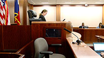 3-1.jpg A photo of a judge in a courtroom with an empty witness chair to her right.