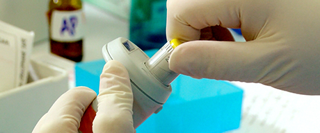 5-1.jpg Photo of a swab from a sexual assault kit inserted into a test tube for testing by a crime lab scientist.