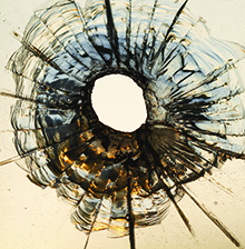 511284645 Bullet hole in glass