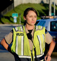 female-officer-200X216.jpg Female law enforcement officer in yellow vest