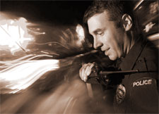 Officer on radio Officer on radio in front of passing headlights