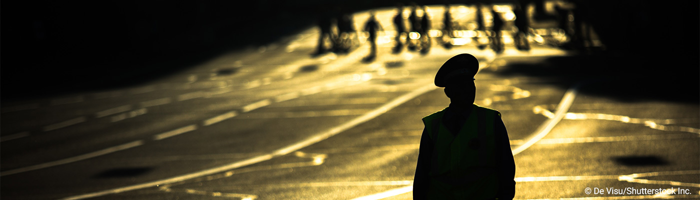 police officer standing in a roadway hero background police officer standing in a roadway