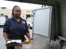 principles_of_dna_03_-_transportation.jpeg Photo of a woman organizing evidence in the back of a van