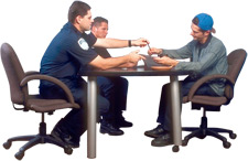 principles_of_dna_10_-_consent.jpeg Photo of police interrogation where police are handing suspect a pen