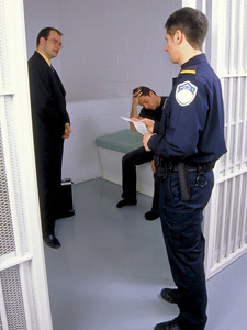 principles_of_dna_10_-_right_to_counsel.jpeg Photo of a jail cell, a lawyer is talking with a prisoner, with a police officer looking in.