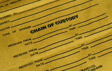principles_of_dna_11_-_chain_of_custody.jpeg Zoomed in photo of an evidence bag where the words "Chain of Custody" can be read