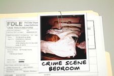 principles_of_dna_11_-_crime_scene_folder.jpeg Photo of an open case file with a crime scene photo