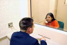 principles_of_dna_11_-_defense_theory.jpeg photo of a defense attorney to a defendant behind glass