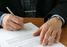 principles_of_dna_11_-_motion.jpeg Photo of a man signing a piece of paper