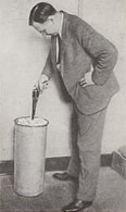 firearms_examiner_02_-_calvin_goddard_firing_pistol.jpg Photo of Calvin Goddard firing a gun into a cylindrical container