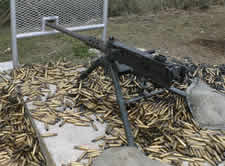firearms_examiner_03_-_machine_gun.jpg Photo of a Machine gun on a pile of bullets