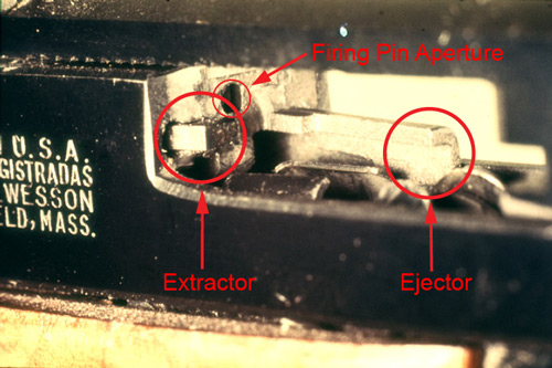 firearms_examiner_09_-_physical_characteristics_1.jpg Extractor, ejector and firing pin aperture of a Smith and Wesson pistol