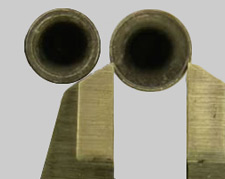 firearms_examiner_10_-_caliber_3.jpg Deep hollow-based lead bullets, held by calipers.