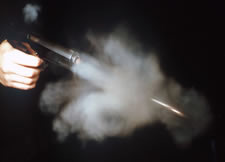 firearms_examiner_12_-_residues_consistent_2.jpg Pistol firing showing residue from muzzle and ejection port