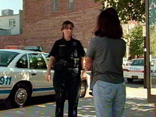Domestic Violence Photo of officer interviewing woman for a domestic violence complaint.