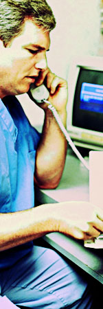 bph_coordinating.jpeg Man at a hospital in scrubs on the telephone