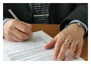 communicatelegislature_gathering.jpeg photo of a man's hands signing a piece of paper