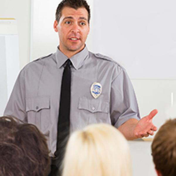 Officer speaking to a group of people.
