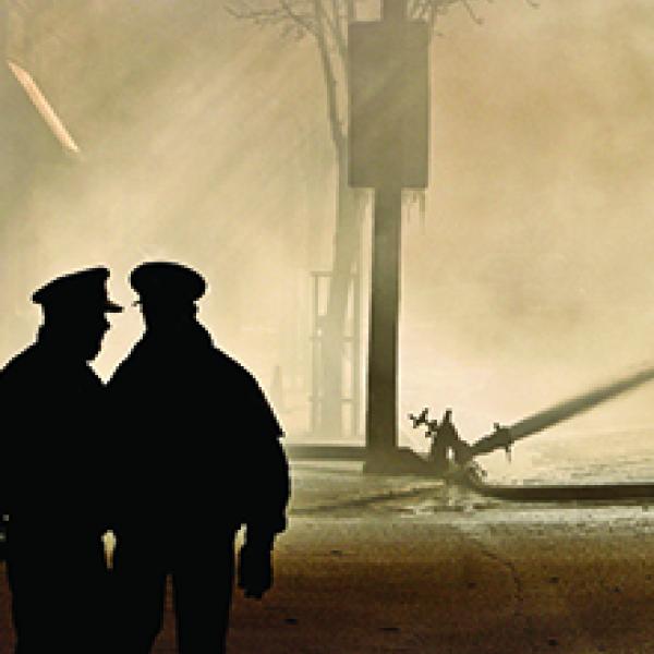 Two officers overlooking a disaster scene